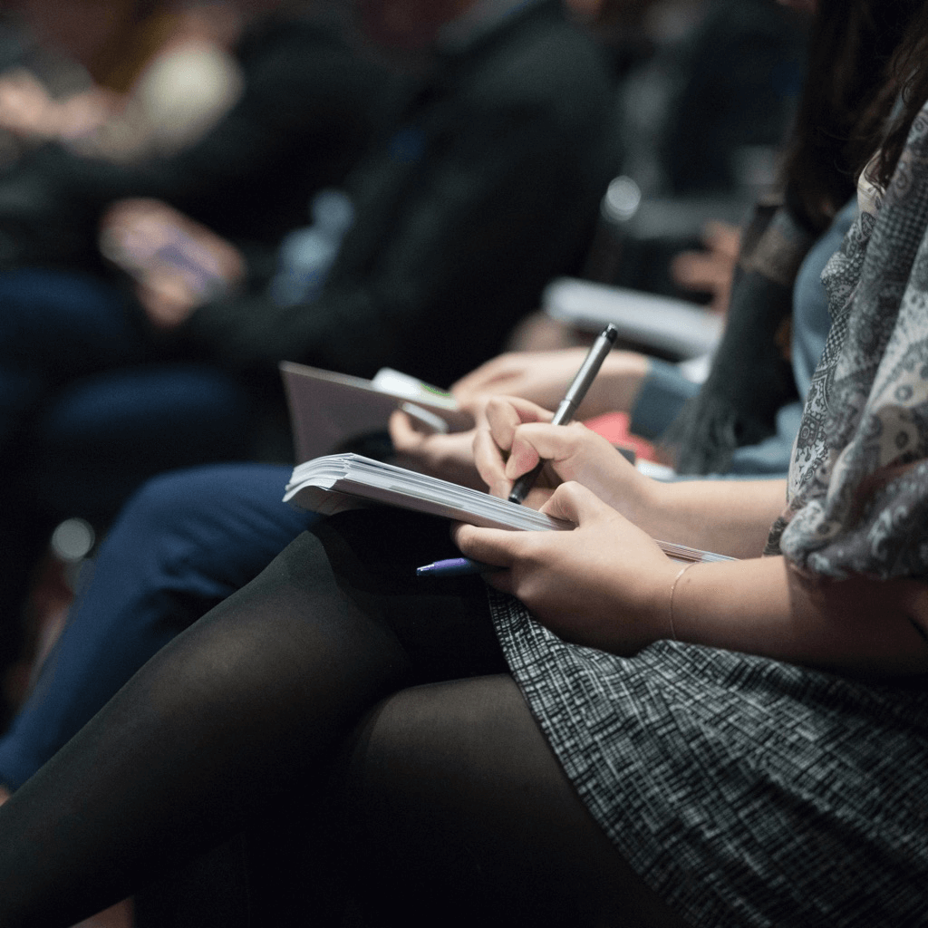 Fort Worth conference attendees writing in notebooks